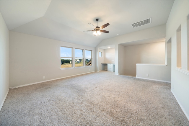 carpeted spare room featuring lofted ceiling and ceiling fan