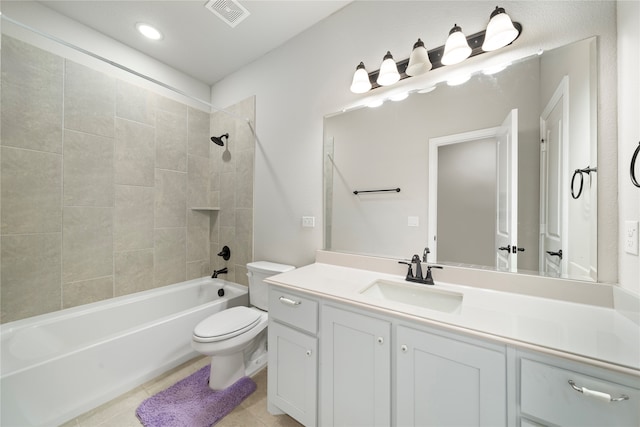 full bathroom featuring tiled shower / bath combo, vanity, toilet, and tile patterned floors