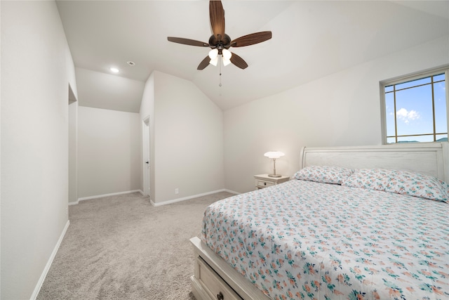 carpeted bedroom featuring ceiling fan and vaulted ceiling