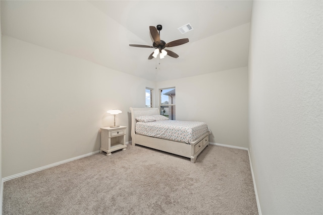 bedroom with ceiling fan, light carpet, and vaulted ceiling