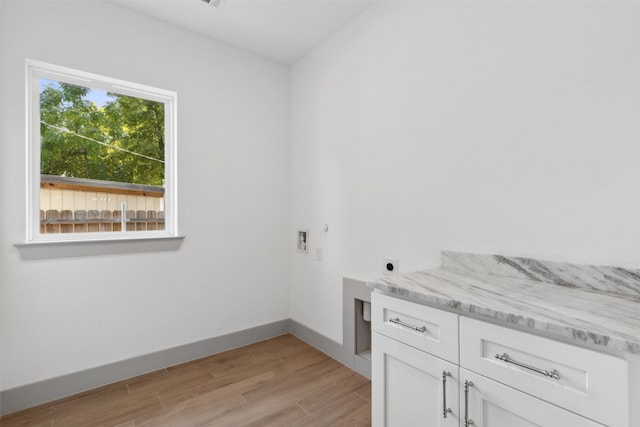 laundry room with washer hookup, cabinets, light wood-type flooring, and electric dryer hookup