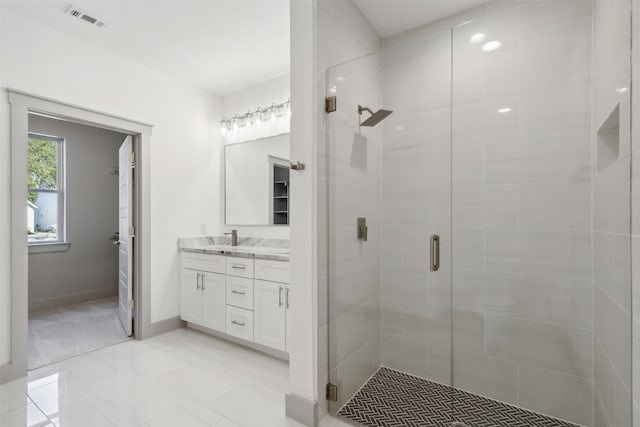 bathroom featuring vanity and a shower with door