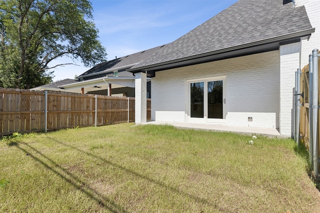 rear view of property featuring a yard