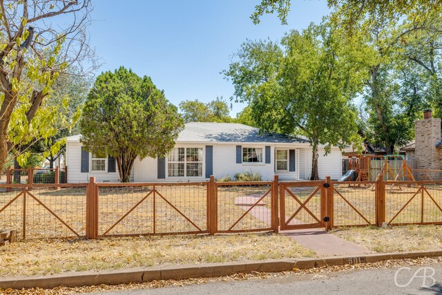 ranch-style house with a playground