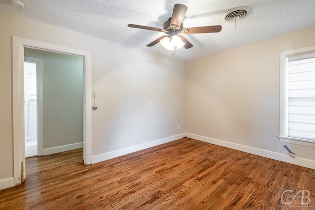 unfurnished room featuring wood-type flooring, a textured ceiling, and ceiling fan