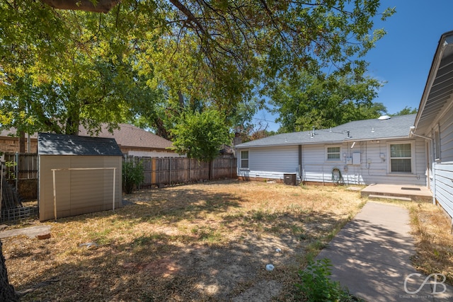 view of yard with a storage unit and central AC