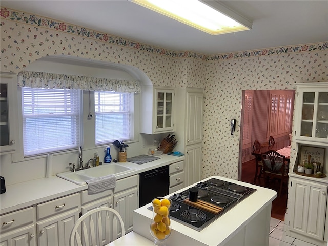 kitchen featuring sink, light tile patterned flooring, dishwasher, white cabinets, and electric cooktop