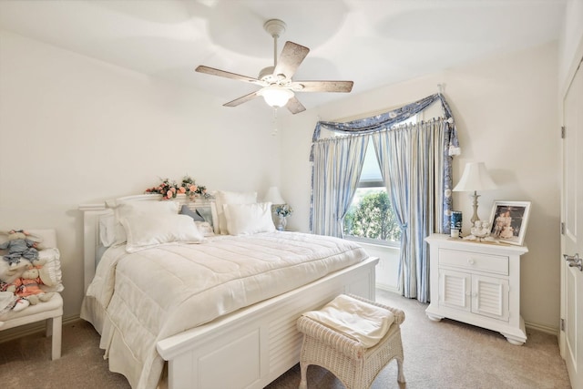 bedroom featuring ceiling fan and light carpet