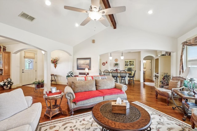 living room with ceiling fan, vaulted ceiling with beams, and hardwood / wood-style flooring