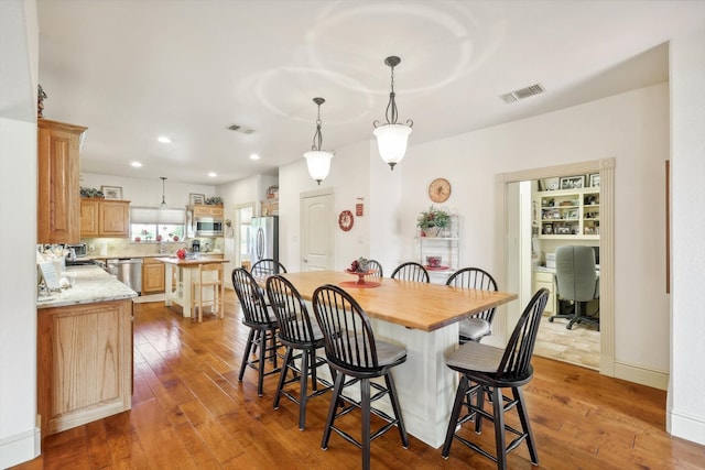 dining area with light hardwood / wood-style floors