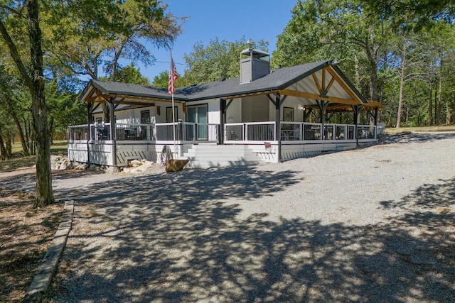 exterior space featuring covered porch and an outdoor structure