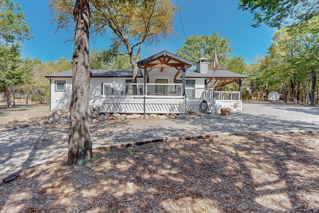 view of front of home with a deck and a shed