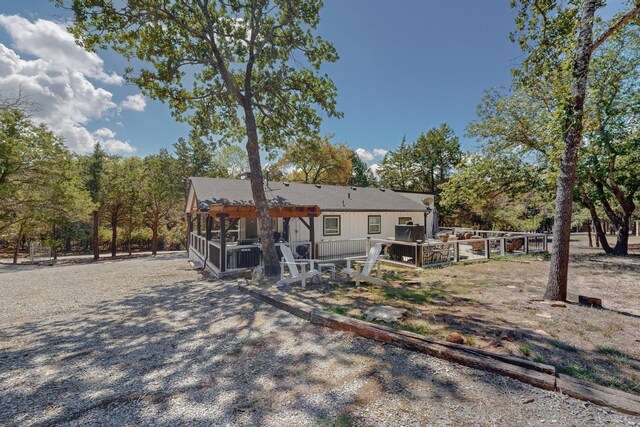 rear view of house with a pergola and a wooden deck