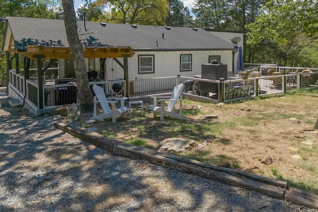 back of property with a wooden deck