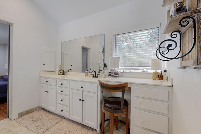 bathroom featuring vanity and vaulted ceiling