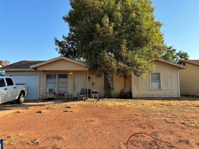 view of front of house featuring a garage and cooling unit