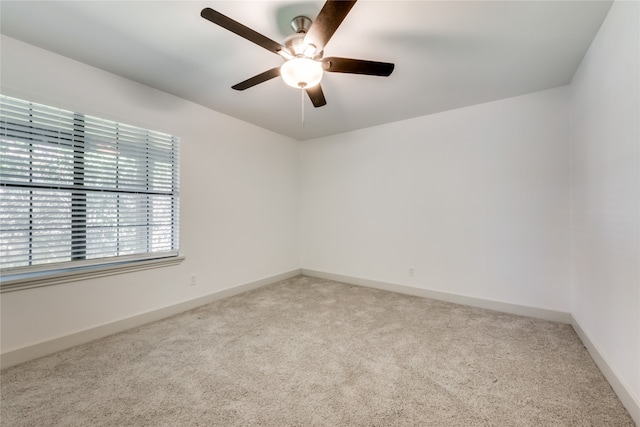 spare room featuring ceiling fan and light colored carpet