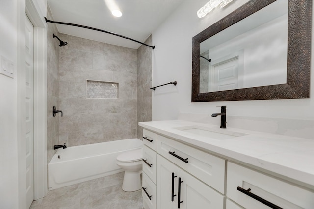 full bathroom featuring tile patterned flooring, vanity, toilet, and tiled shower / bath