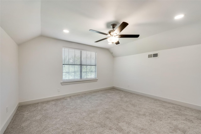 carpeted empty room featuring ceiling fan and vaulted ceiling