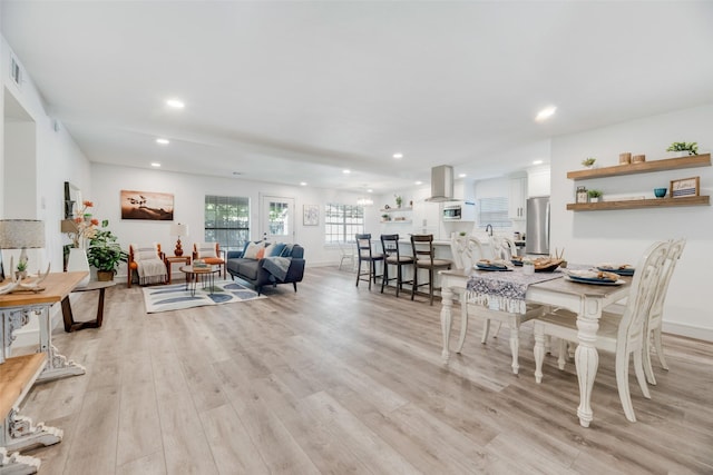 dining area featuring light wood-type flooring, baseboards, and recessed lighting