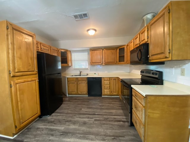 kitchen with sink, black appliances, and dark wood-type flooring