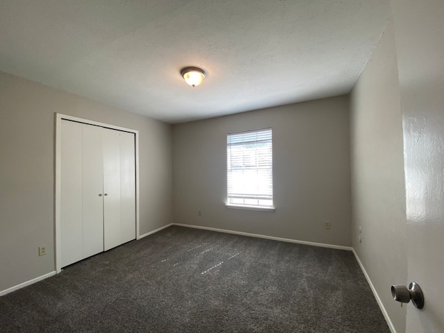 unfurnished bedroom featuring carpet and a closet