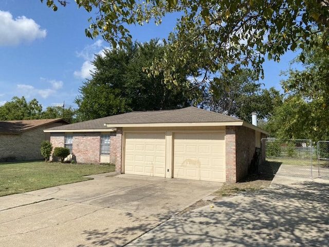 view of front of home with a front lawn, concrete driveway, fence, and brick siding