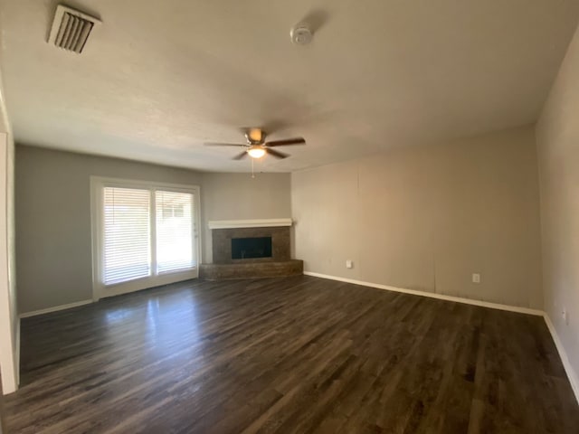 unfurnished living room with ceiling fan and dark hardwood / wood-style flooring