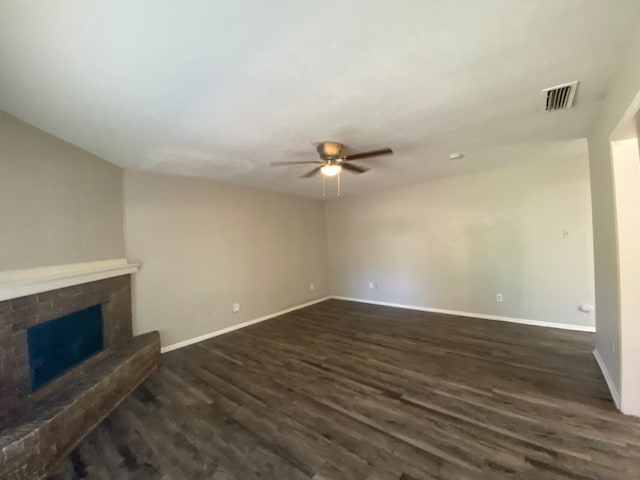 unfurnished living room featuring ceiling fan and dark wood-type flooring