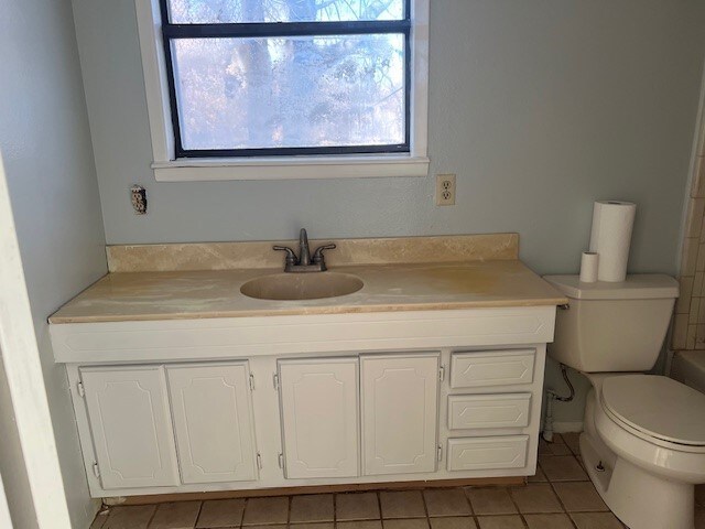 bathroom with tile patterned floors, vanity, and toilet