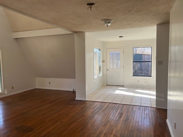 foyer entrance featuring light hardwood / wood-style floors and a textured ceiling