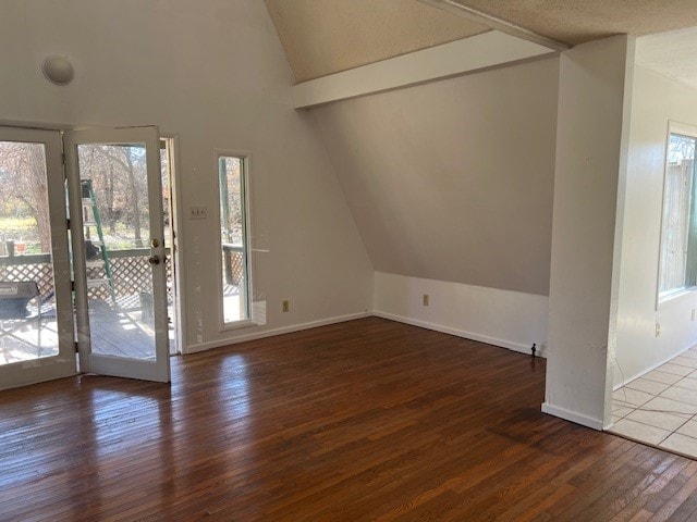 interior space with dark hardwood / wood-style flooring and vaulted ceiling