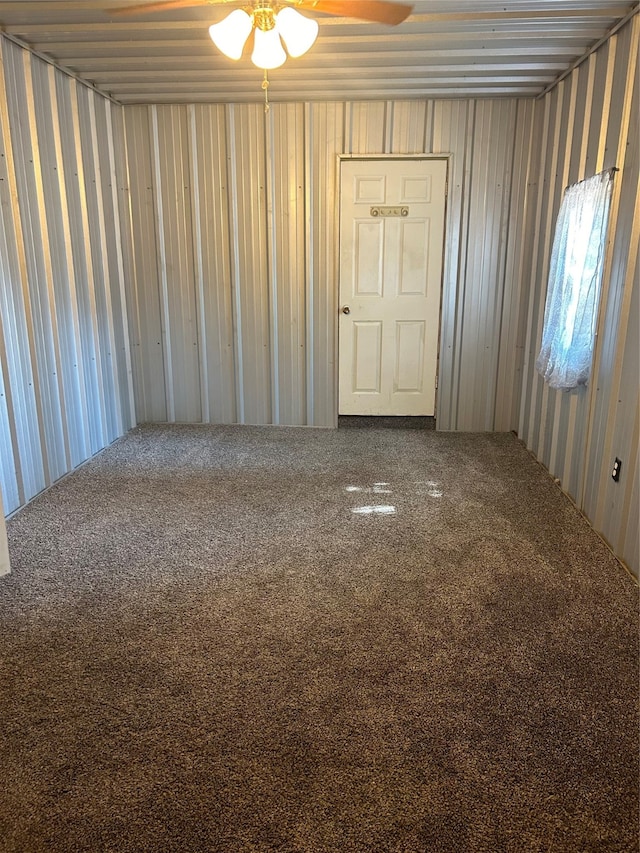 empty room featuring ceiling fan and carpet floors