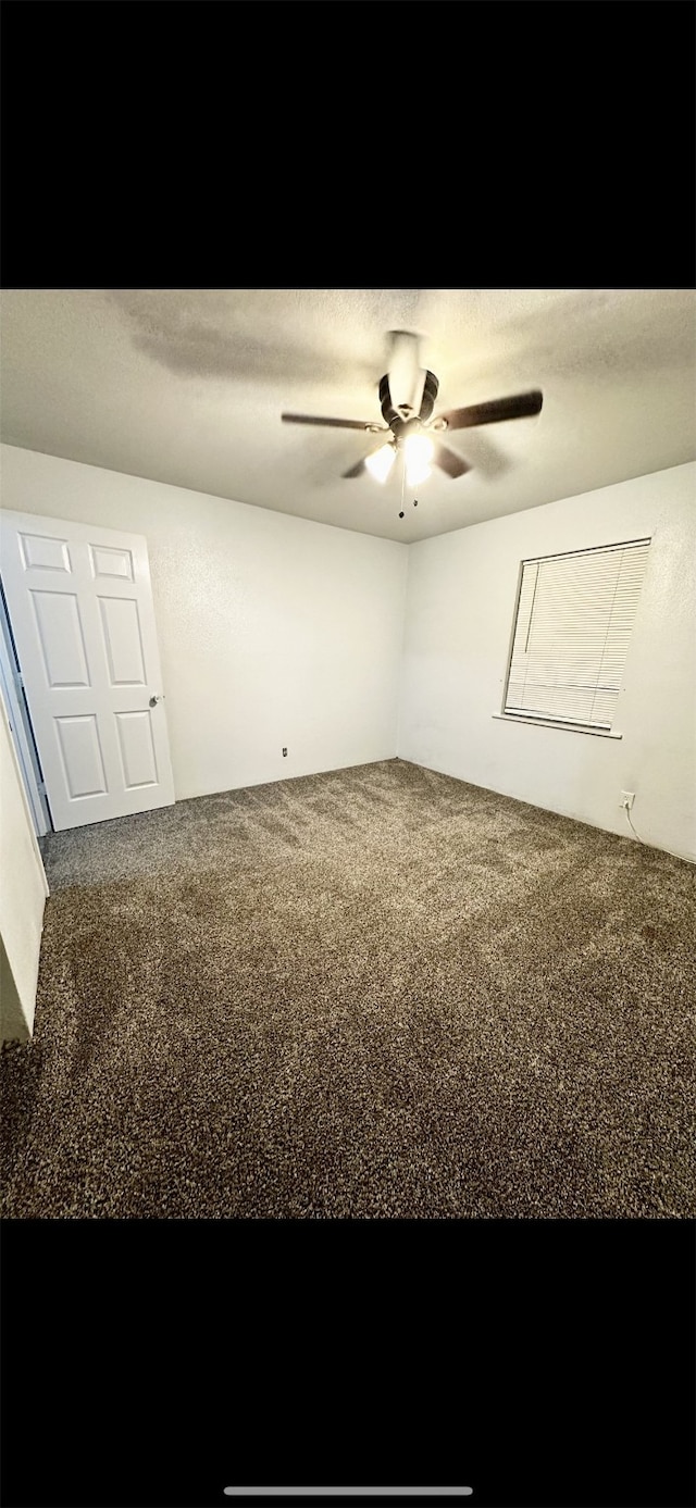 carpeted empty room with ceiling fan