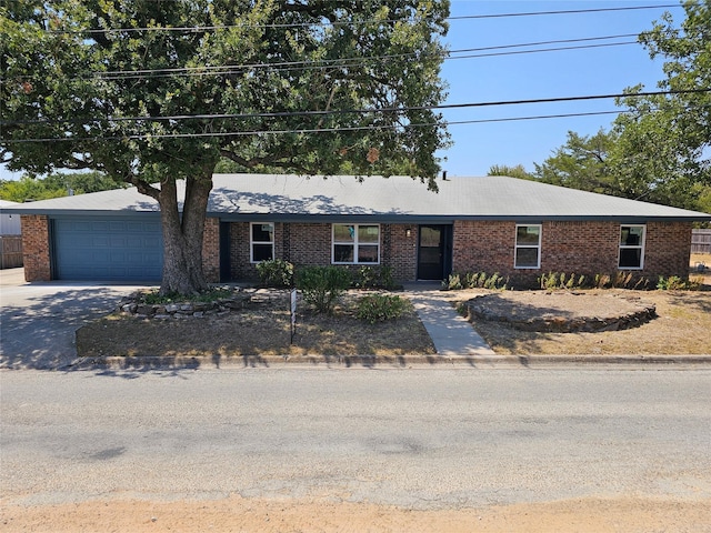 ranch-style home with brick siding, driveway, and an attached garage