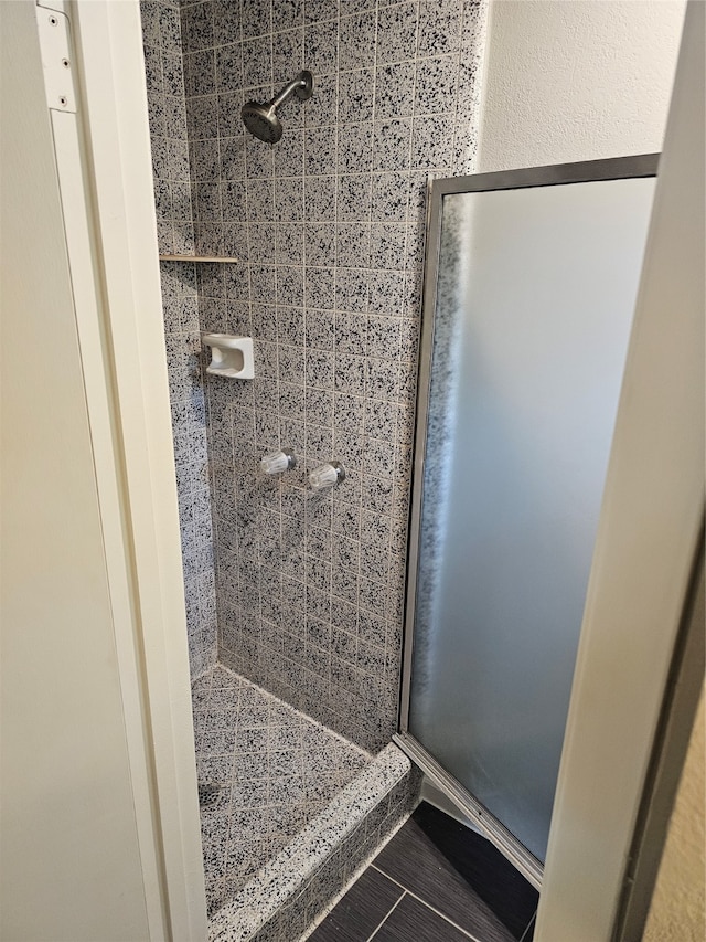 bathroom with walk in shower and tile patterned floors