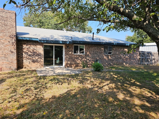 back of house featuring a patio and a yard