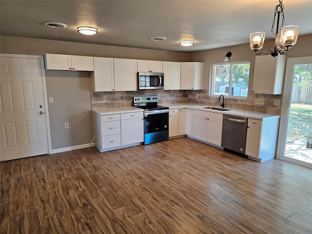 unfurnished living room featuring a large fireplace, baseboards, dark wood-style floors, and visible vents