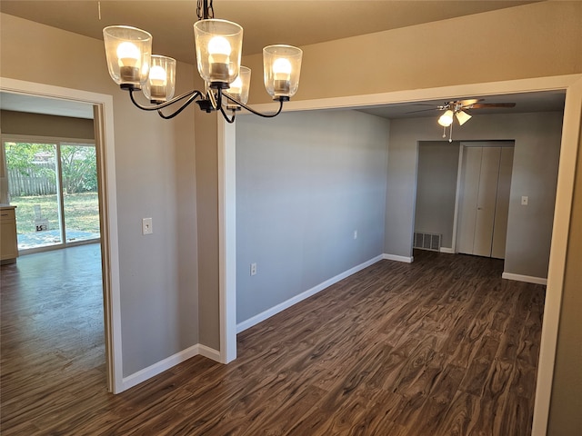 spare room with ceiling fan with notable chandelier and dark hardwood / wood-style floors