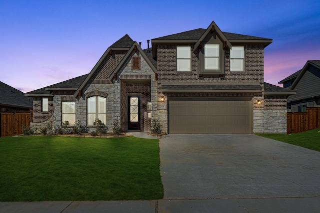 view of front facade with a garage and a lawn