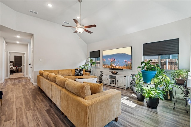 living room with ceiling fan, high vaulted ceiling, and hardwood / wood-style floors