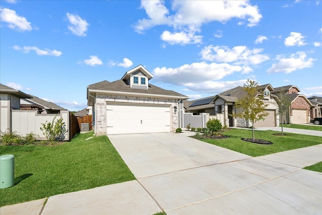 view of front of house with a front yard and a garage