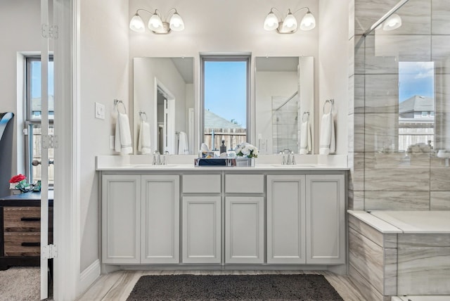 bathroom with an enclosed shower and vanity