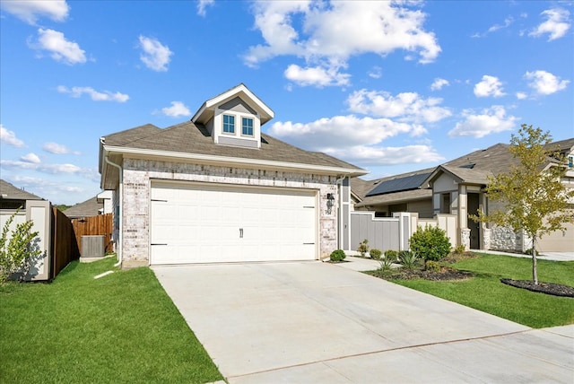 view of front facade featuring a front lawn, central air condition unit, solar panels, and a garage