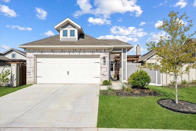 view of front of property with a garage and a front lawn