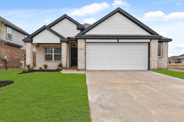 view of front facade featuring a lawn and a garage