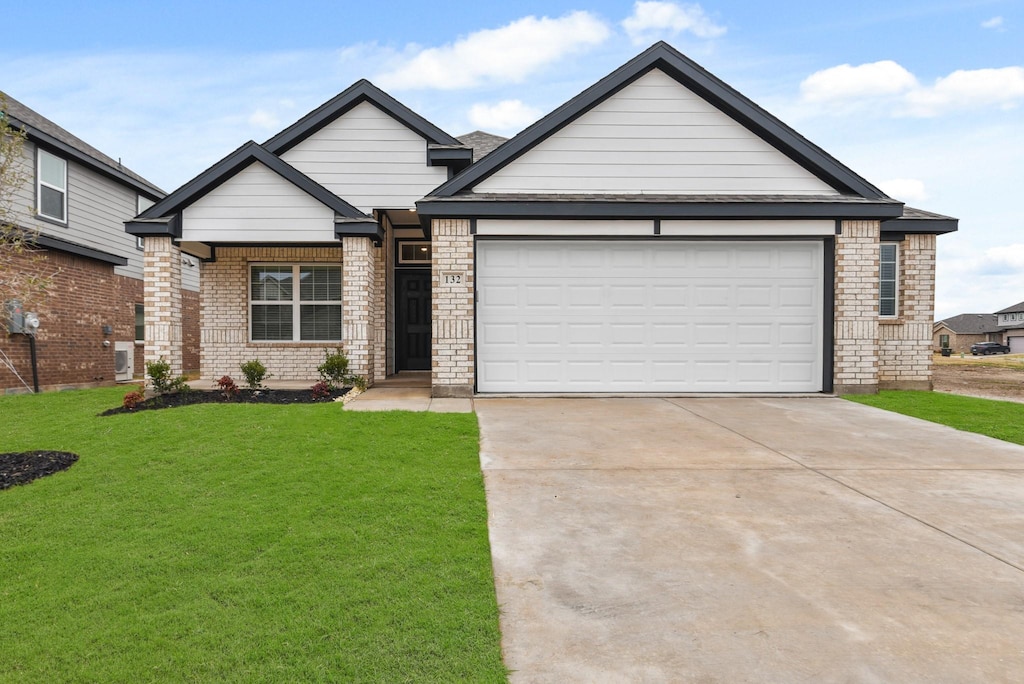 view of front of property with a garage and a front lawn