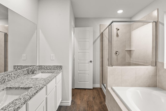 bathroom featuring vanity, hardwood / wood-style floors, and separate shower and tub