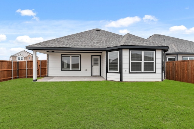 back of house featuring a yard and a patio area