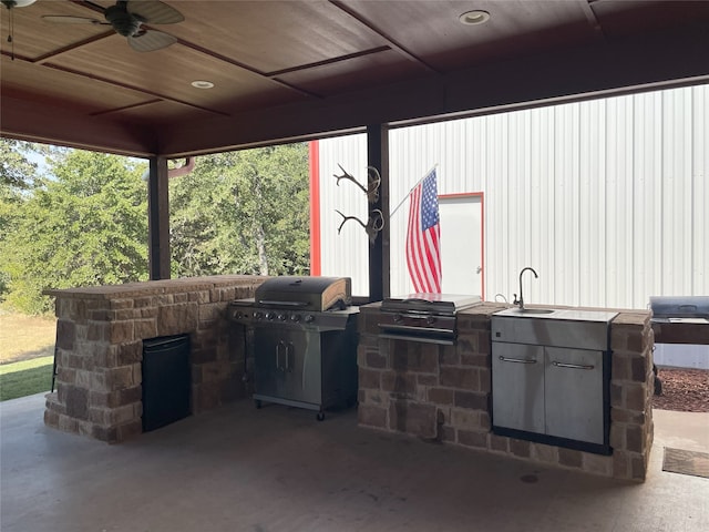 view of patio featuring ceiling fan, sink, and exterior kitchen